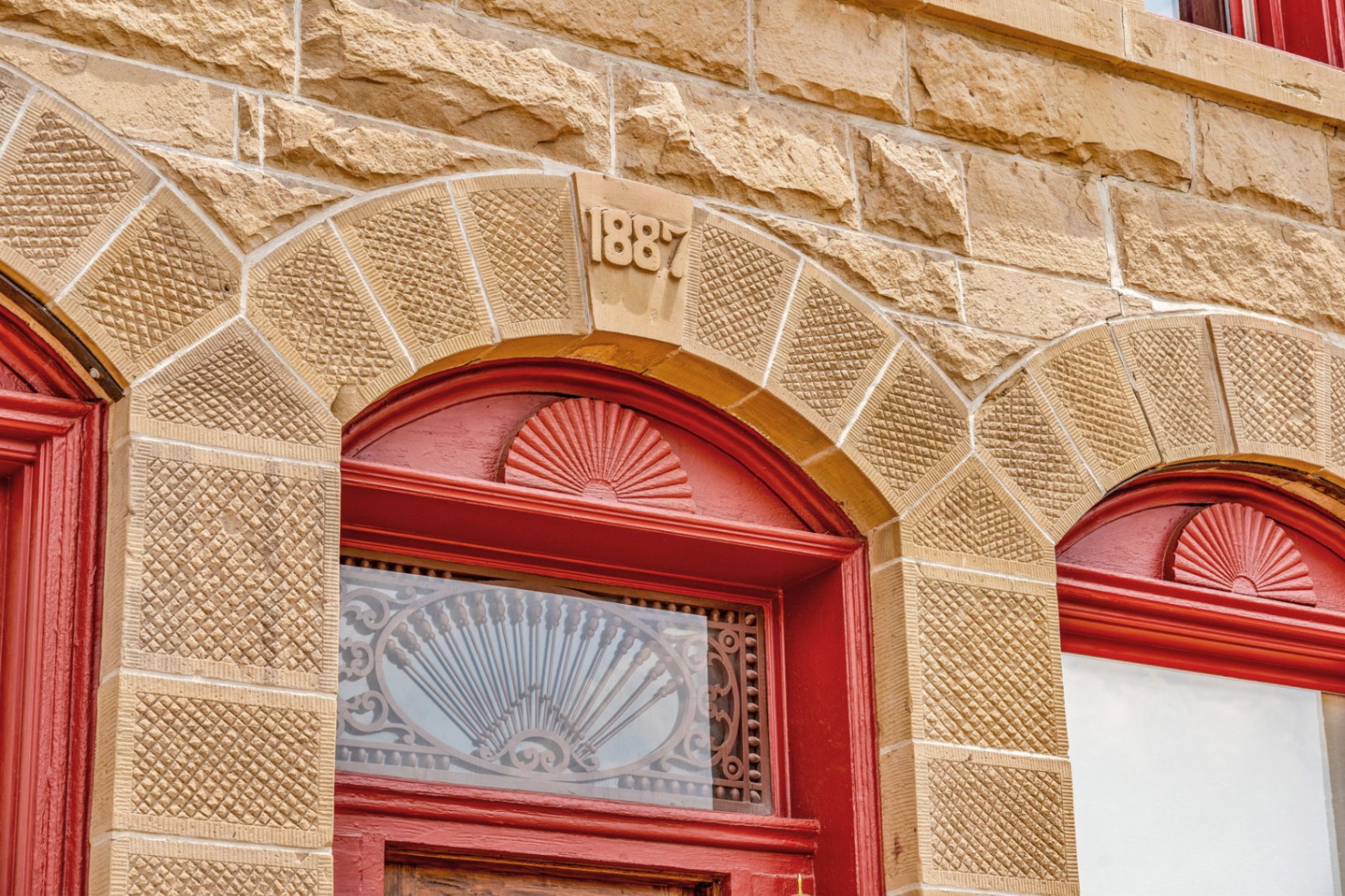 Ornate 1887 sandstone archway above the hotel entrance